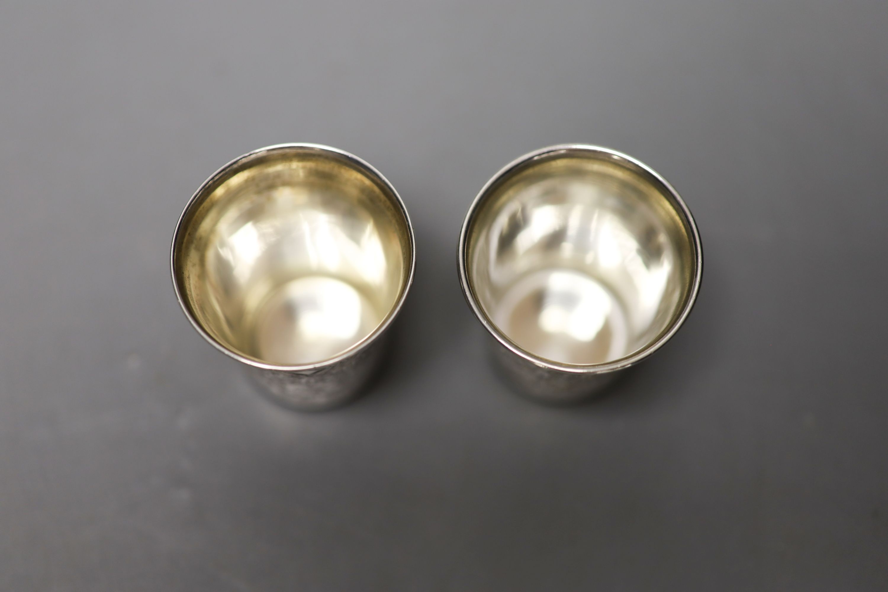 A pair of 19th century Russian engraved 84 zolotnik tots, dated 1879, 48mm, 52 grams.